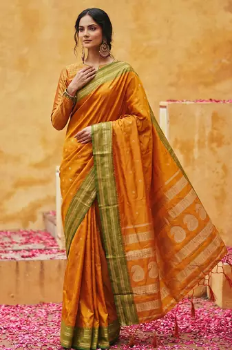 the sunset glow: vibrant orange soft silk blend saree with contrast green zari border