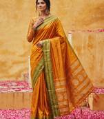 the sunset glow: vibrant orange soft silk blend saree with contrast green zari border