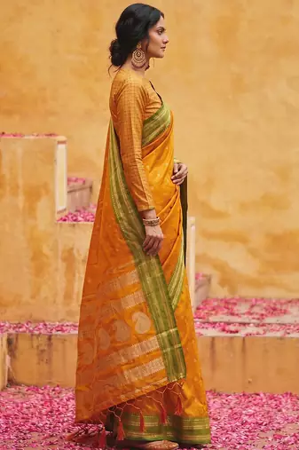 the sunset glow: vibrant orange soft silk blend saree with contrast green zari border