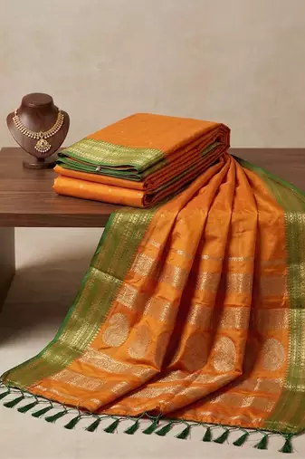 the sunset glow: vibrant orange soft silk blend saree with contrast green zari border