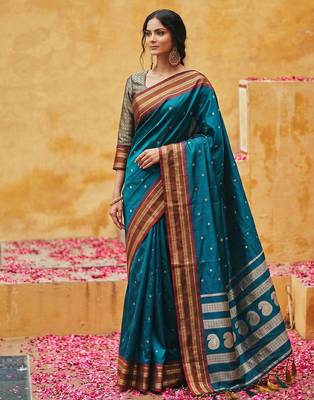 the peacock hue: teal blue soft silk blend saree with contrast red zari border 1