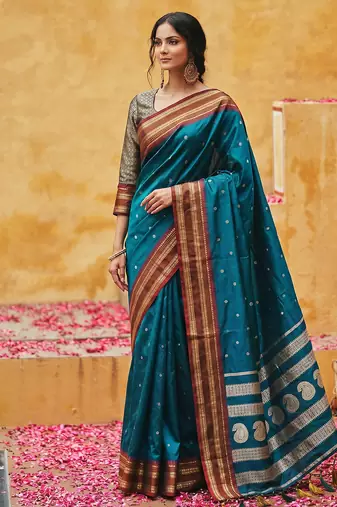the peacock hue: teal blue soft silk blend saree with contrast red zari border