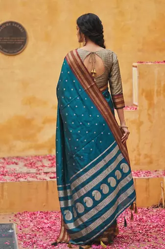 the peacock hue: teal blue soft silk blend saree with contrast red zari border