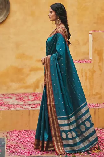 the peacock hue: teal blue soft silk blend saree with contrast red zari border