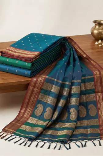 the peacock hue: teal blue soft silk blend saree with contrast red zari border