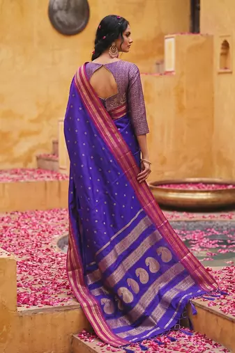 the blue soft silk blend saree with contrast red zari border