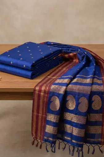the blue soft silk blend saree with contrast red zari border