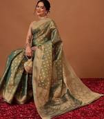 Teal woven tissue party wear saree with blouse piece