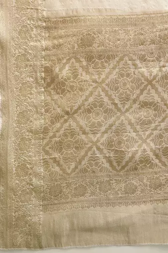 Off white woven tissue party wear saree with blouse piece