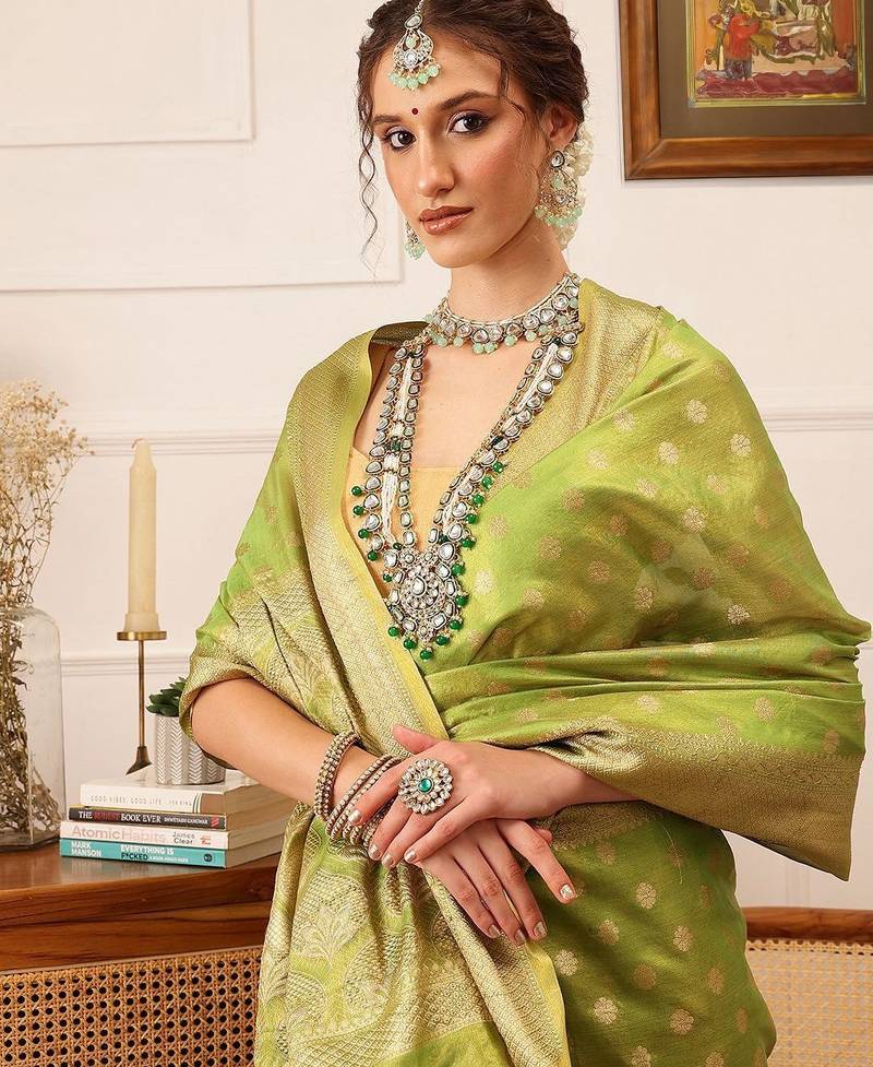 Green woven tissue party wear saree with blouse piece