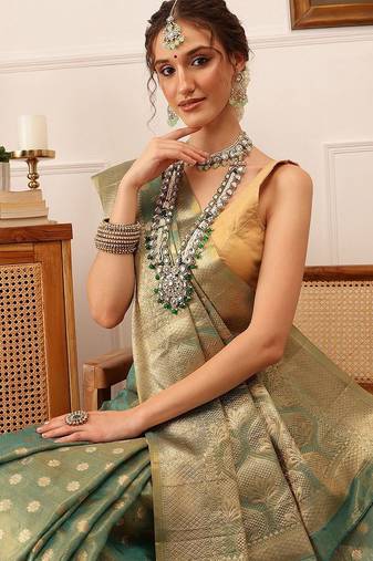 Teal woven tissue party wear saree with blouse piece