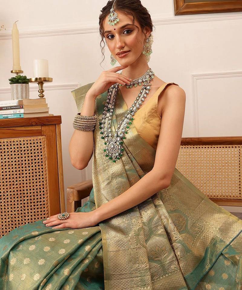 Teal woven tissue party wear saree with blouse piece