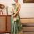 Teal woven tissue party wear saree with blouse piece