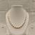 Pearl necklace set with gold-tone spacer rings, white oval freshwater pearls, round stud earrings included