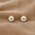 Pearl stud earrings, white freshwater pearl with gold-tone claw setting, classic elegant style
