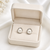 Pearl stud earrings, white freshwater pearl, silver-tone crown setting, classic elegant jewellery.