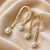 Gold-tone hammered arc drop earrings with freshwater pearl dangles, elegant stud style