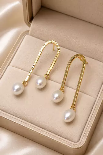 Gold-tone hammered arc drop earrings with freshwater pearl dangles, elegant stud style