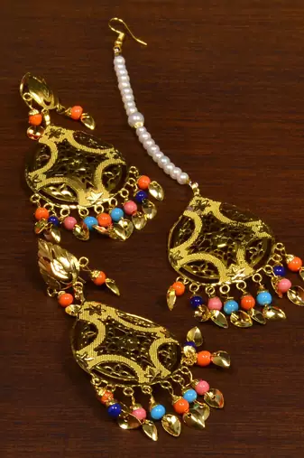 Festive multicolor gold tone earrings and tikka set
