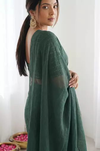  dark bottle green solid saree with embellished blouse