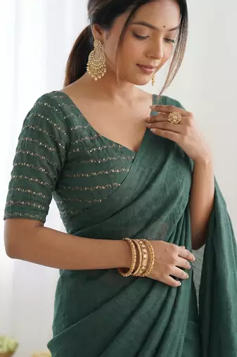  dark bottle green solid saree with embellished blouse