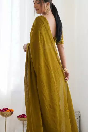 New trendy elegant gold solid saree with embellished blouse
