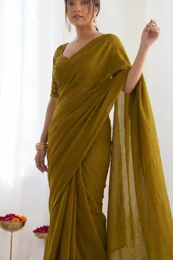 New trendy elegant gold solid saree with embellished blouse