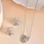 Elegant interlocked heart design with fine stone detailing
