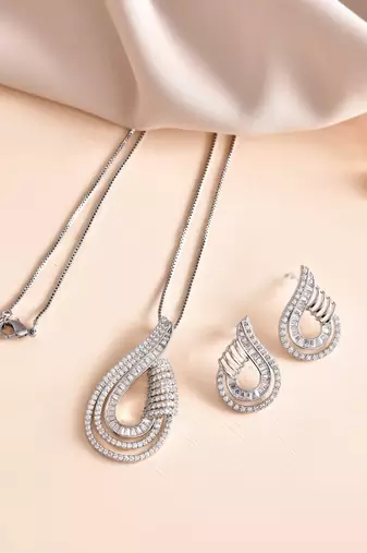 Luxury teardrop diamond pendant  set in silver finish with matching earrings