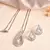 Luxury teardrop diamond pendant  set in silver finish with matching earrings