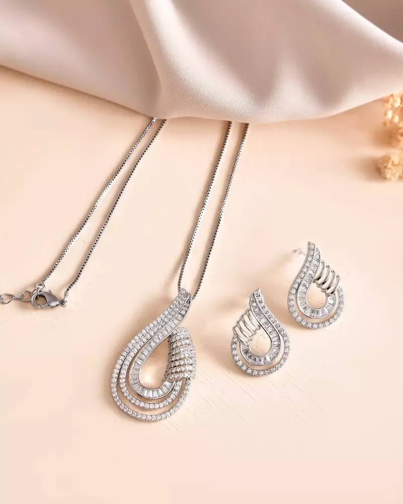 Luxury teardrop diamond pendant  set in silver finish with matching earrings