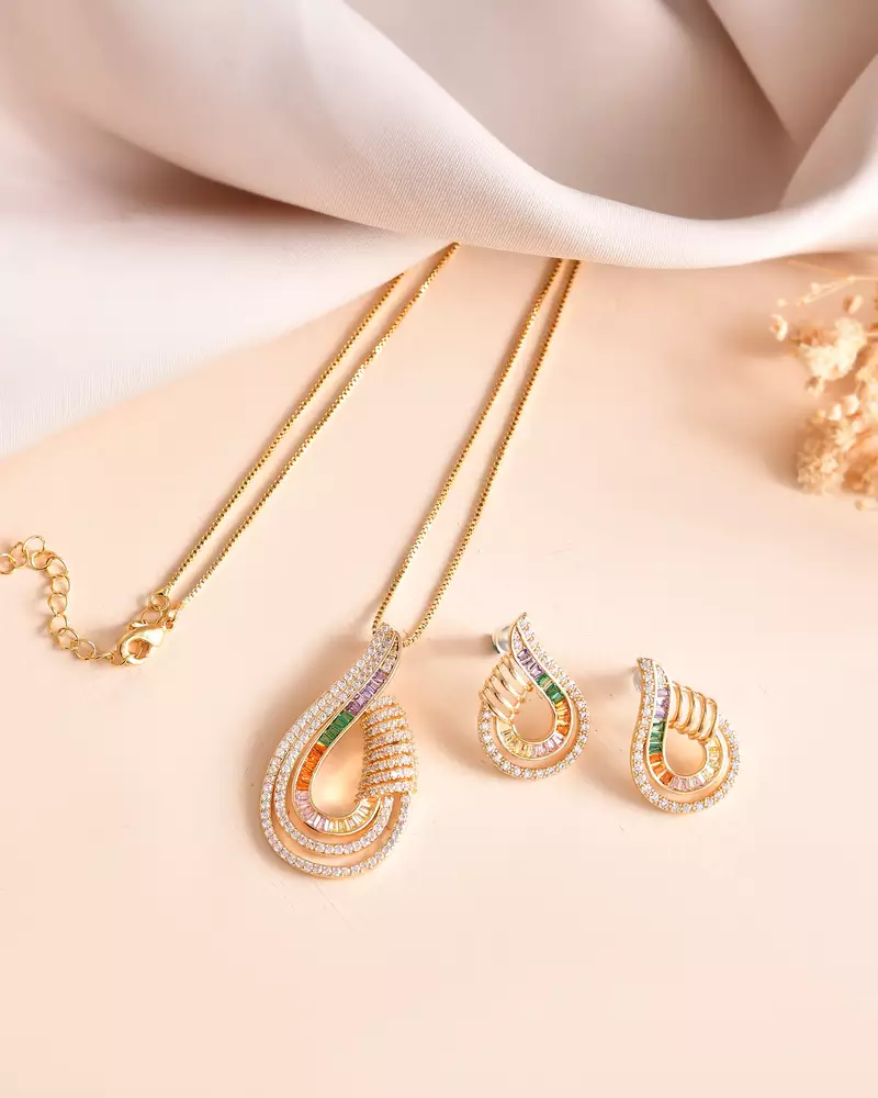 Luxury teardrop diamond pendant  set in gold finish with matching earrings