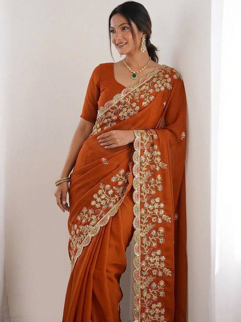 Rust colour party wear rangoli silk embroidered saree