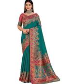 Teal position print with zari weaving saree with contrast blouse piece
