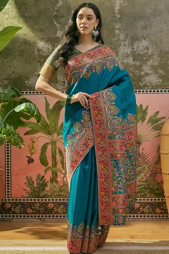 Teal position print with zari weaving saree with contrast blouse piece