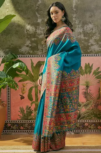 Teal position print with zari weaving saree with contrast blouse piece