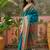 Teal position print with zari weaving saree with contrast blouse piece
