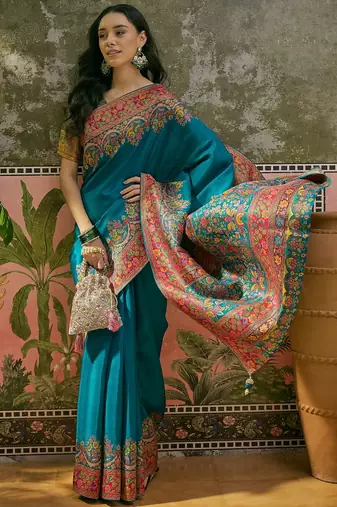 Teal position print with zari weaving saree with contrast blouse piece