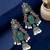 Silver oxidised peacock motif green jhumka earrings