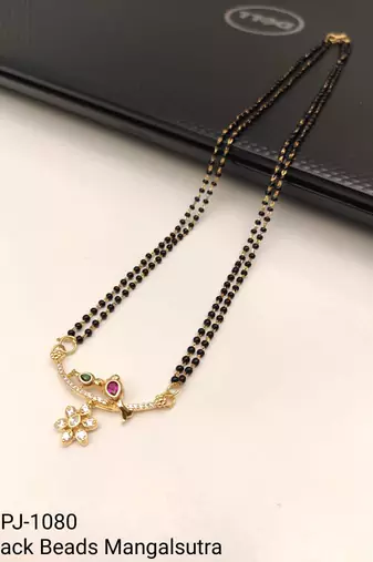 Traditional double strand black bead mangalsutra with gold-toned floral cz pendant, ruby & emerald accents