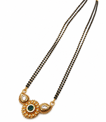 Traditional mangalsutra with double strand black beads, gold-toned kundan pendant, green stone