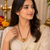 Traditional mangalsutra with double strand black beads, gold-toned kundan pendant, green stone