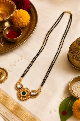 Traditional mangalsutra with double strand black beads, gold-toned kundan pendant, green stone