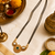 Traditional mangalsutra with double strand black beads, gold-toned kundan pendant, green stone