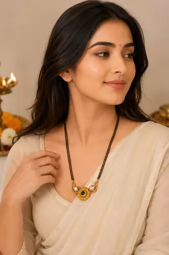 Traditional mangalsutra with double strand black beads, gold-toned kundan pendant, green stone