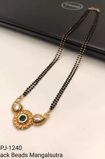 Traditional mangalsutra with double strand black beads, gold-toned kundan pendant, green stone
