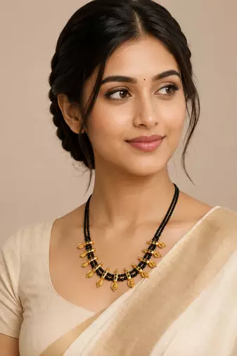 Traditional black beaded mangalsutra necklace, gold-toned, triple strand, lakshmi coin charms, green stone accents