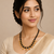 Traditional black beaded mangalsutra necklace, gold-toned, triple strand, lakshmi coin charms, green stone accents