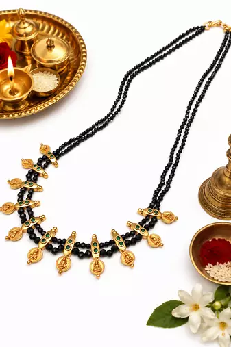 Traditional black beaded mangalsutra necklace, gold-toned, triple strand, lakshmi coin charms, green stone accents