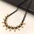 Traditional black beaded mangalsutra necklace, gold-toned, triple strand, lakshmi coin charms, green stone accents